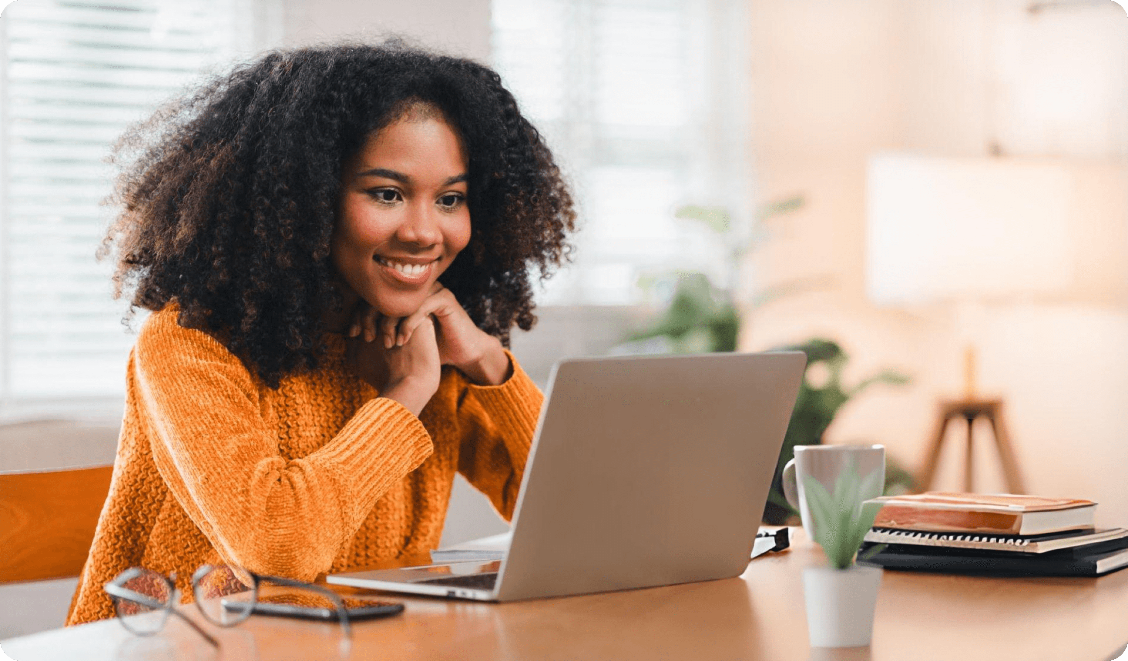 A creator smiling at her laptop, her whole business running behind a single login