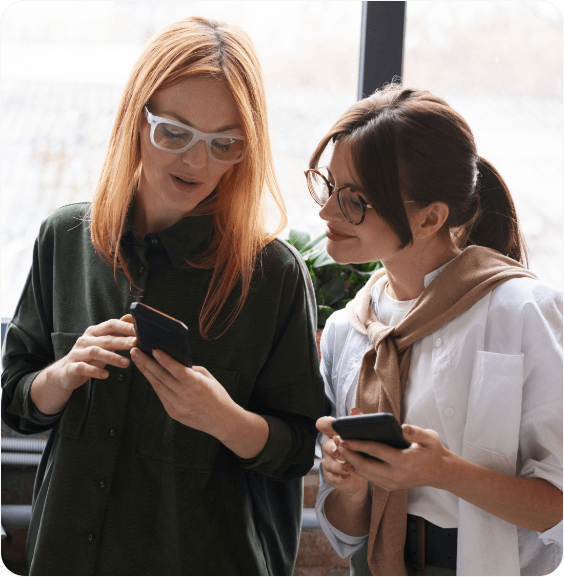 Two people checking a message together on a phone