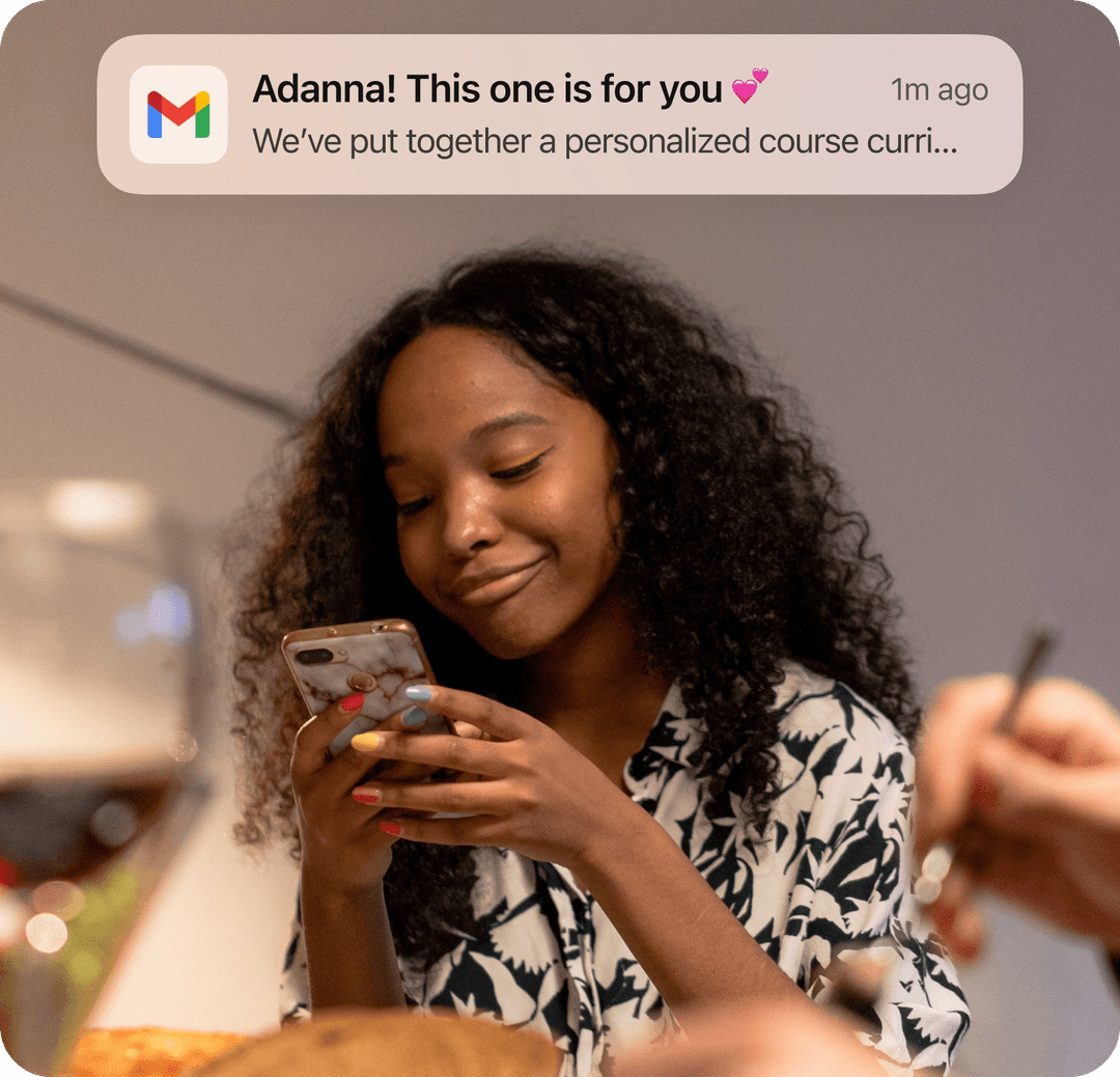 Person smiling at their phone after receiving a personalized email